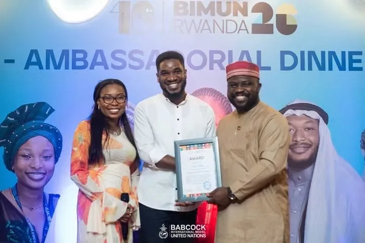 Paul Udah receiving a certificate at the BIMUN Rwanda Ambassadorial Dinner